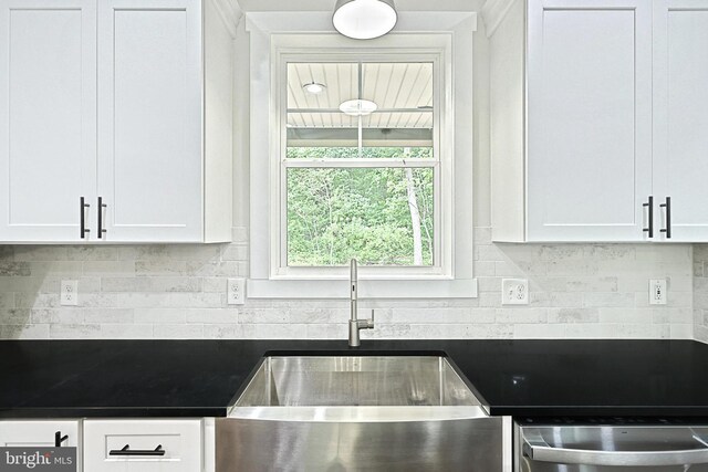 2741 Primrose Ln N, York, PA 17404 - kitchen featuring dark countertops, white cabinetry, backsplash, and a sink
