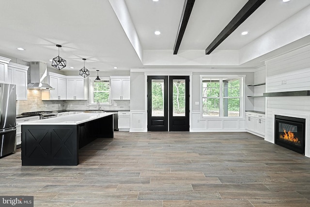 2741 Primrose Ln N, York, PA 17404 - kitchen featuring wall chimney range hood, appliances with stainless steel finishes, a sink, recessed lighting, and tasteful backsplash