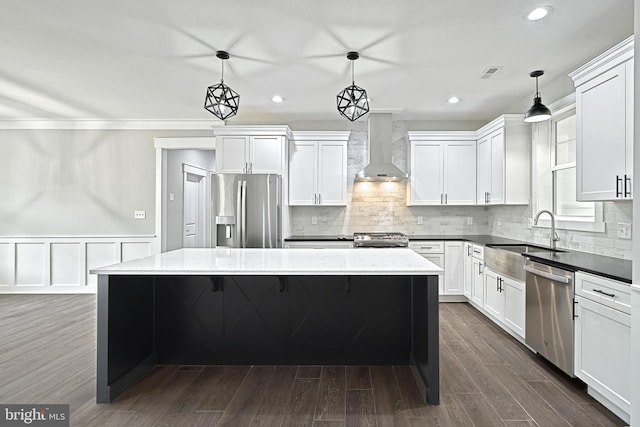 2741 Primrose Ln N, York, PA 17404 - kitchen with wall chimney range hood, stainless steel appliances, a sink, a center island, and white cabinetry