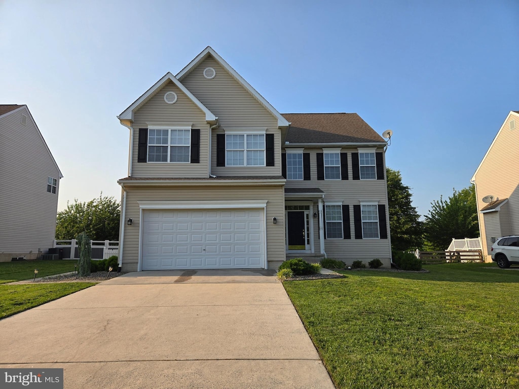1011 W Birdie Ln, Magnolia, DE 19962 - view of front of home with an attached garage, concrete driveway, and a front lawn