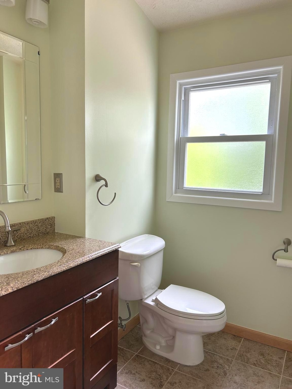 245 Carvel Rd, Pasadena, MD 21122 - half bathroom with baseboards, vanity, toilet, and tile patterned floors