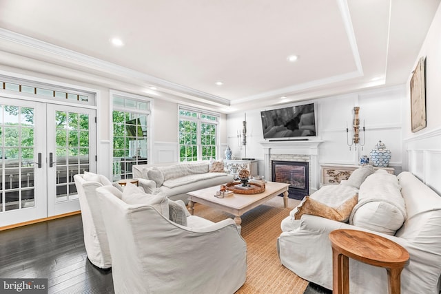 3209 Henson Ave, Annapolis, MD 21403 - living area with a decorative wall, a tray ceiling, a stone fireplace, dark wood-type flooring, and ornamental molding