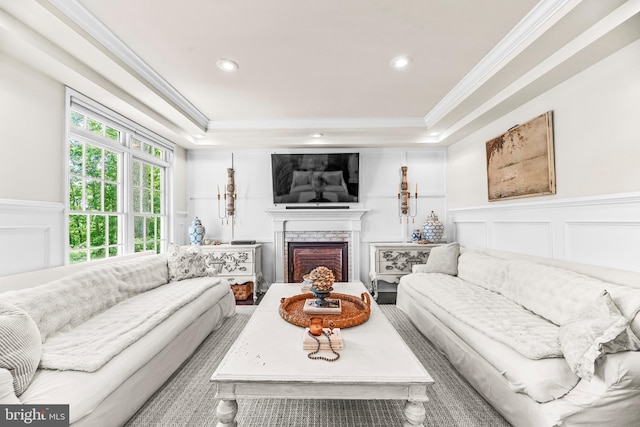 3209 Henson Ave, Annapolis, MD 21403 - living room featuring ornamental molding, a decorative wall, a tray ceiling, a fireplace, and a wainscoted wall
