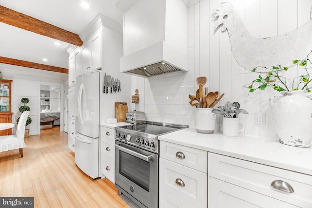 3209 Henson Ave, Annapolis, MD 21403 - kitchen with custom exhaust hood, high end range, freestanding refrigerator, backsplash, and white cabinets