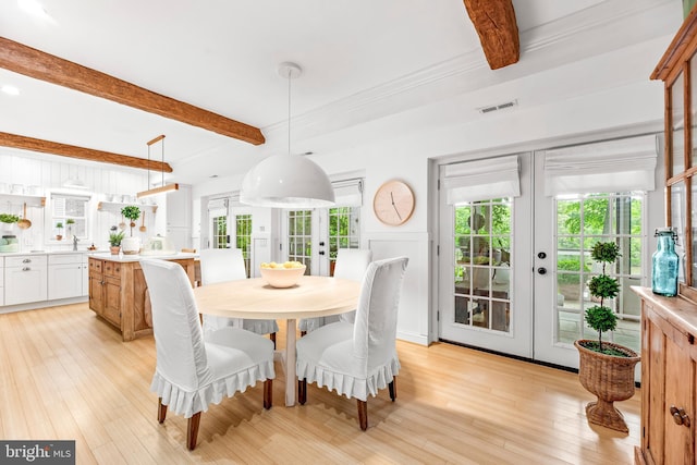 3209 Henson Ave, Annapolis, MD 21403 - dining space featuring french doors, beam ceiling, light wood-type flooring, and healthy amount of natural light