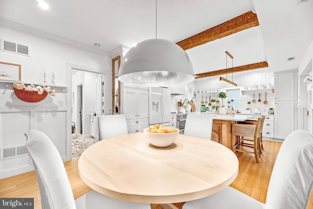 3209 Henson Ave, Annapolis, MD 21403 - dining space featuring light wood finished floors and ornamental molding