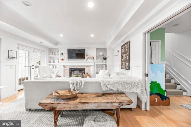 3209 Henson Ave, Annapolis, MD 21403 - living area with light wood-style floors, ornamental molding, stairway, a glass covered fireplace, and recessed lighting