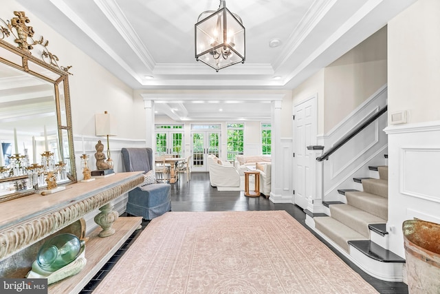 3209 Henson Ave, Annapolis, MD 21403 - foyer featuring a tray ceiling, a decorative wall, a chandelier, dark wood-style flooring, and wainscoting