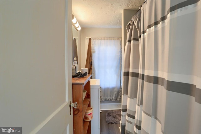 4160 W Market St, York, PA 17408 - full bath featuring a textured ceiling, vanity, wood finished floors, and curtained shower