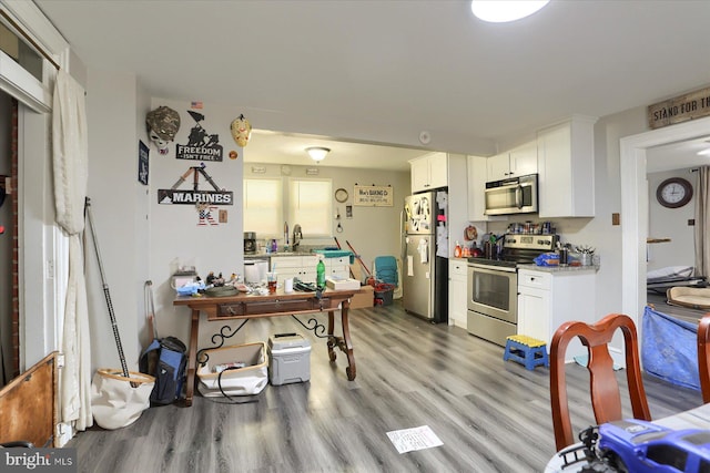 4160 W Market St, York, PA 17408 - kitchen with stainless steel appliances, white cabinets, light wood-type flooring, light countertops, and a sink