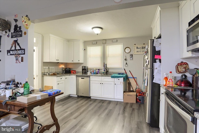 4160 W Market St, York, PA 17408 - kitchen with stainless steel appliances, white cabinets, light wood finished floors, and light stone countertops