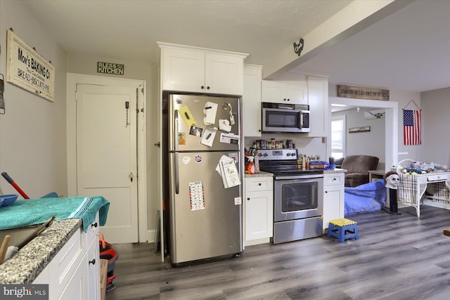 4160 W Market St, York, PA 17408 - kitchen with appliances with stainless steel finishes, dark wood-type flooring, white cabinets, and light stone counters