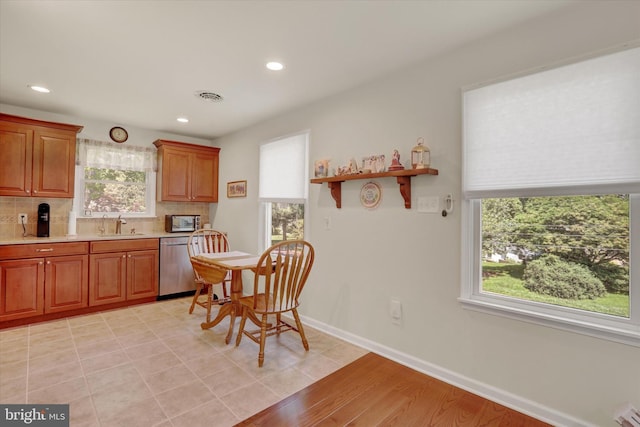 143 Brittany Dr, Chalfont, PA 18914 - kitchen with stainless steel appliances, light countertops, tasteful backsplash, recessed lighting, and brown cabinetry