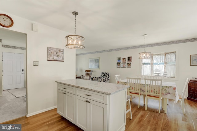 143 Brittany Dr, Chalfont, PA 18914 - kitchen featuring a chandelier, light wood finished floors, white cabinetry, a kitchen island, and pendant lighting