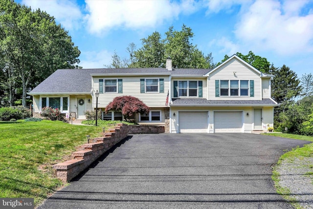 143 Brittany Dr, Chalfont, PA 18914 - view of front of house featuring driveway, stone siding, an attached garage, a chimney, and a front yard