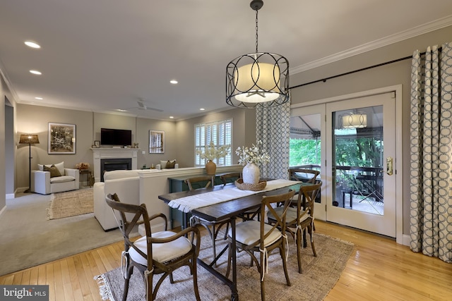 2149 Colleens Way, Lancaster, PA 17601 - dining area with crown molding, light wood finished floors, a fireplace, recessed lighting, and baseboards