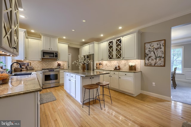 2149 Colleens Way, Lancaster, PA 17601 - kitchen with stainless steel appliances, a sink, ornamental molding, backsplash, and white cabinets
