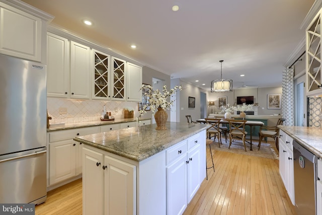 2149 Colleens Way, Lancaster, PA 17601 - kitchen with stainless steel appliances, open floor plan, light wood-type flooring, backsplash, and a center island