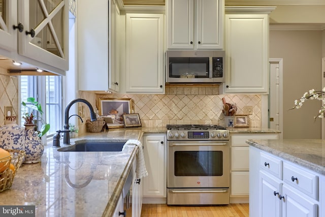 2149 Colleens Way, Lancaster, PA 17601 - kitchen with appliances with stainless steel finishes, a sink, light stone countertops, decorative backsplash, and white cabinetry