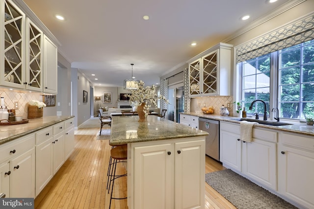 2149 Colleens Way, Lancaster, PA 17601 - kitchen with stainless steel dishwasher, a sink, ornamental molding, glass insert cabinets, and a kitchen island
