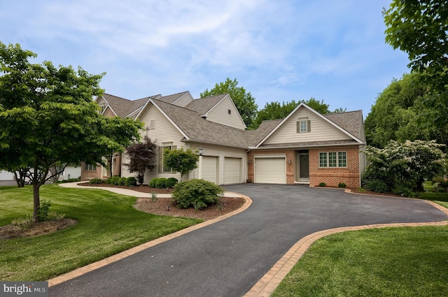 2149 Colleens Way, Lancaster, PA 17601 - view of front of property featuring a garage, driveway, brick siding, a front yard, and roof with shingles