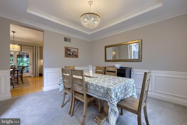 2149 Colleens Way, Lancaster, PA 17601 - dining space featuring a chandelier, a raised ceiling, carpet, a decorative wall, and ornamental molding