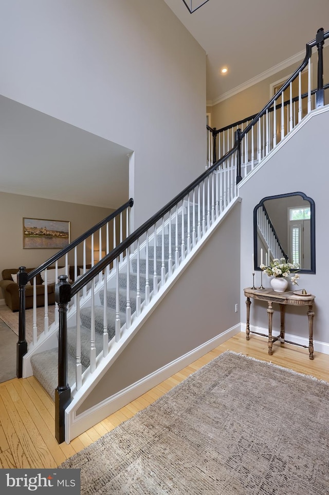 2149 Colleens Way, Lancaster, PA 17601 - stairs featuring wood finished floors, baseboards, recessed lighting, crown molding, and a towering ceiling