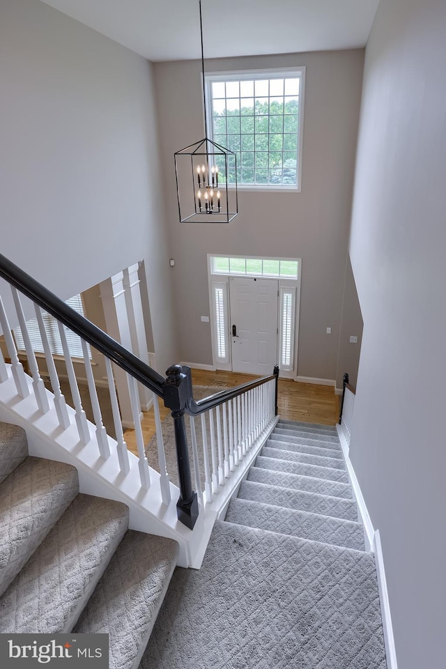 2149 Colleens Way, Lancaster, PA 17601 - entrance foyer featuring stairway, a towering ceiling, a chandelier, baseboards, and carpet