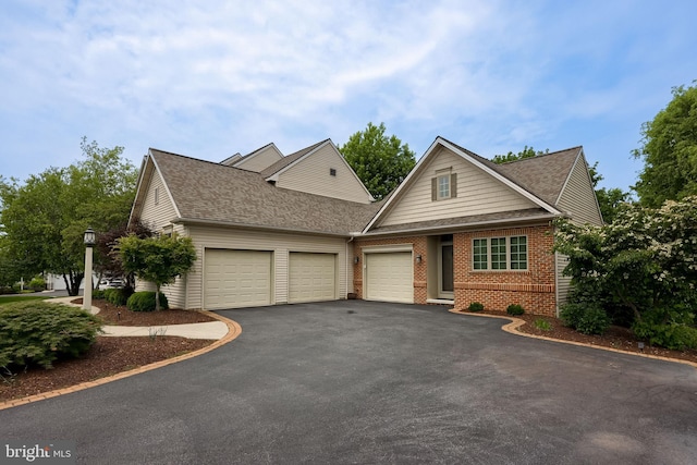 2149 Colleens Way, Lancaster, PA 17601 - view of front of home featuring an attached garage, asphalt driveway, brick siding, and a shingled roof