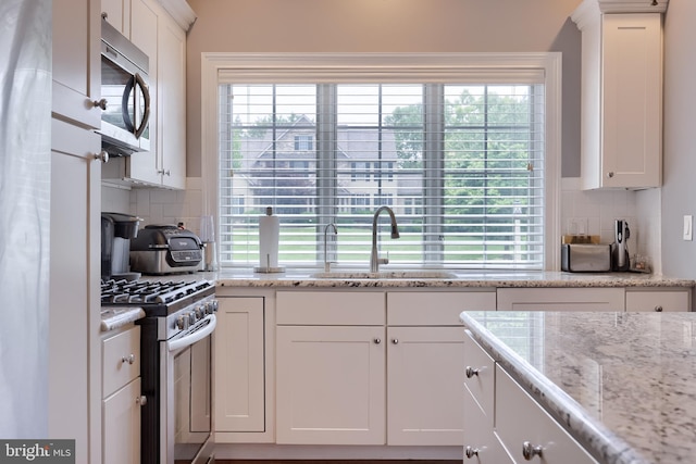 2149 Colleens Way, Lancaster, PA 17601 - kitchen with appliances with stainless steel finishes, a sink, backsplash, and white cabinetry