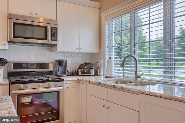 2149 Colleens Way, Lancaster, PA 17601 - kitchen featuring stainless steel appliances, a sink, backsplash, white cabinetry, and light stone countertops