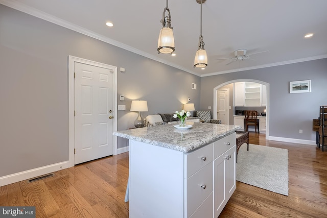 2149 Colleens Way, Lancaster, PA 17601 - kitchen with arched walkways, white cabinetry, crown molding, a ceiling fan, and light wood finished floors