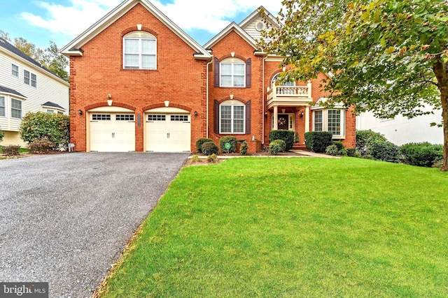3913 Rolling Paddock Dr, Upper Marlboro, MD 20772 - view of front facade featuring driveway, a garage, a front yard, and brick siding