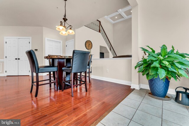 3913 Rolling Paddock Dr, Upper Marlboro, MD 20772 - dining area featuring wood finished floors, baseboards, stairway, a chandelier, and arched walkways