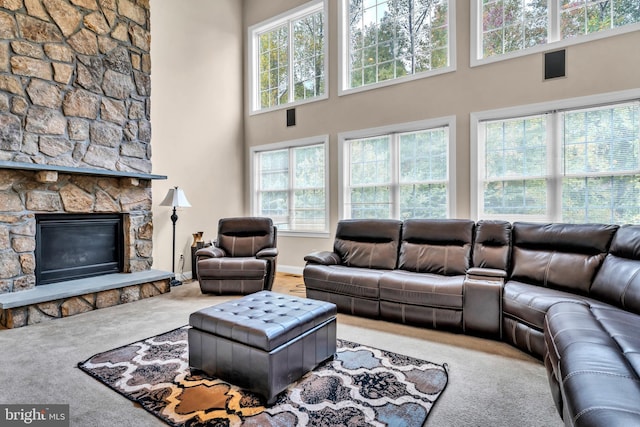 3913 Rolling Paddock Dr, Upper Marlboro, MD 20772 - living room featuring a towering ceiling, carpet flooring, healthy amount of natural light, a fireplace, and baseboards
