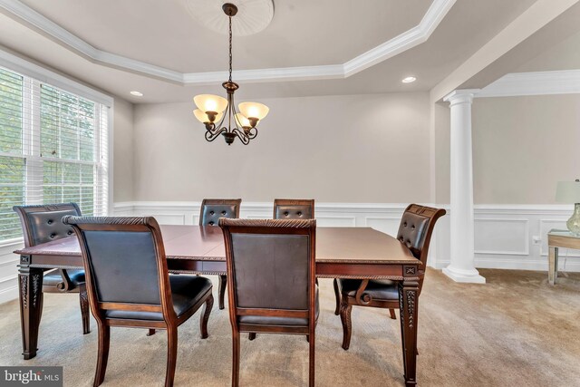 3913 Rolling Paddock Dr, Upper Marlboro, MD 20772 - dining space featuring ornate columns, a tray ceiling, a chandelier, ornamental molding, and light carpet