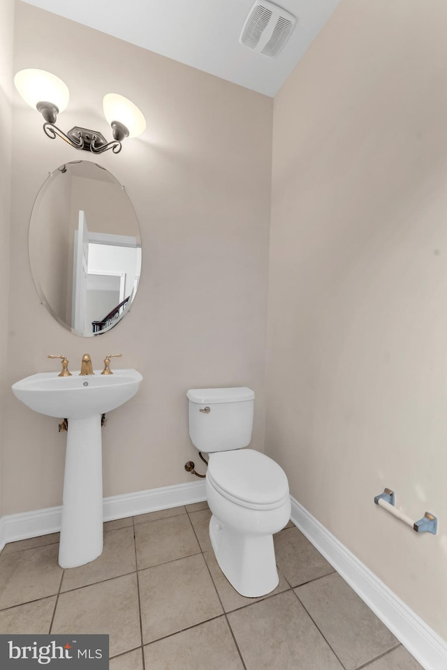 3913 Rolling Paddock Dr, Upper Marlboro, MD 20772 - half bathroom featuring toilet, tile patterned flooring, and baseboards