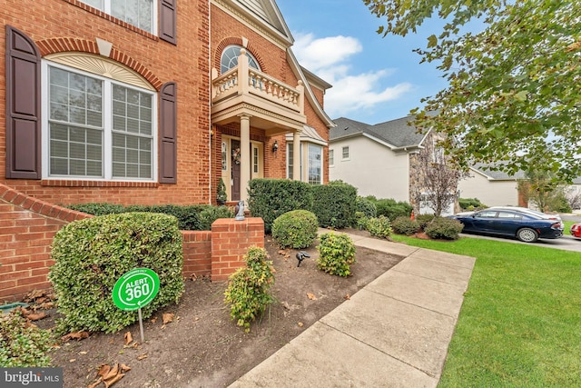 3913 Rolling Paddock Dr, Upper Marlboro, MD 20772 - view of exterior entry with brick siding, a yard, and a balcony