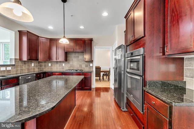 3913 Rolling Paddock Dr, Upper Marlboro, MD 20772 - kitchen featuring dark brown cabinets, stainless steel appliances, hardwood / wood-style floors, hanging light fixtures, and recessed lighting