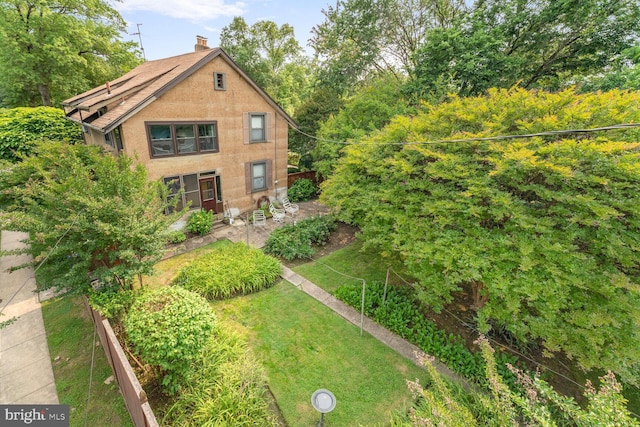 801 23rd St S, Arlington, VA 22202 - rear view of house featuring a chimney, stucco siding, and a lawn
