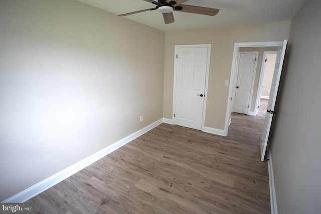 180 Carroll Rd, Pasadena, MD 21122 - unfurnished bedroom featuring wood finished floors, baseboards, and ceiling fan