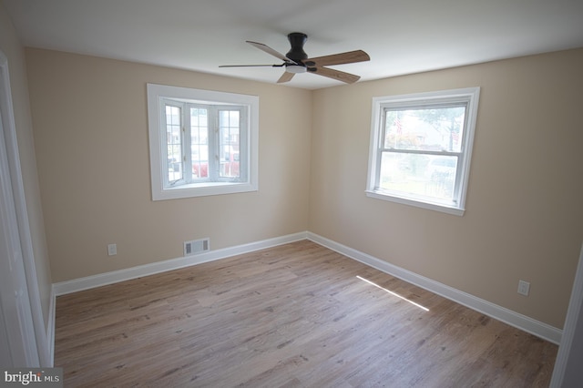 180 Carroll Rd, Pasadena, MD 21122 - unfurnished room with plenty of natural light, ceiling fan, wood finished floors, and baseboards