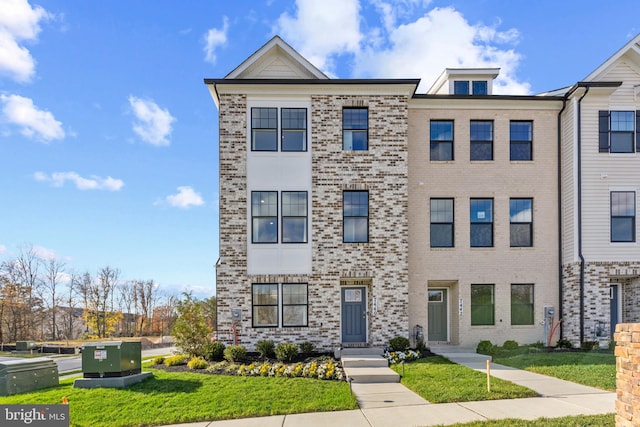 7417 Calm Retreat Blvd, Brandywine, MD 20613 - multi unit property featuring a front yard and brick siding