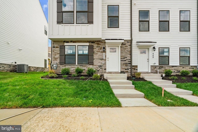 7417 Calm Retreat Blvd, Brandywine, MD 20613 - multi unit property featuring stone siding, central air condition unit, board and batten siding, and a front lawn
