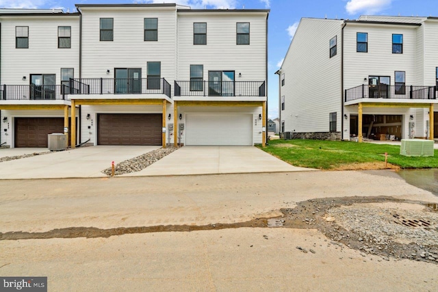 7417 Calm Retreat Blvd, Brandywine, MD 20613 - rear view of property with an attached garage, cooling unit, concrete driveway, and a balcony