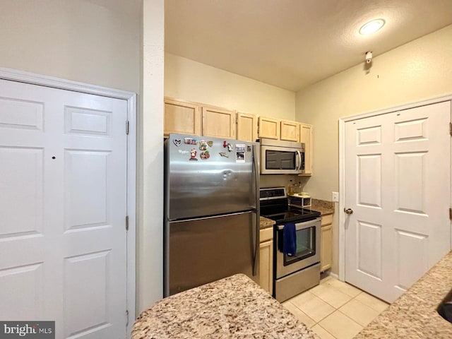 1581 Spring Gate Dr Unit 5207, Mclean, VA 22102 - kitchen with appliances with stainless steel finishes, light brown cabinets, light tile patterned flooring, and light stone counters