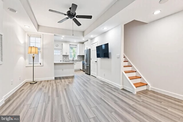 1523 N Hollywood St, Philadelphia, PA 19121 - unfurnished living room with light wood finished floors, ceiling fan, baseboards, stairs, and recessed lighting