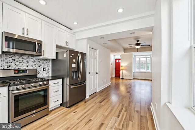 1523 N Hollywood St, Philadelphia, PA 19121 - kitchen featuring appliances with stainless steel finishes, white cabinets, a ceiling fan, baseboards, and tasteful backsplash