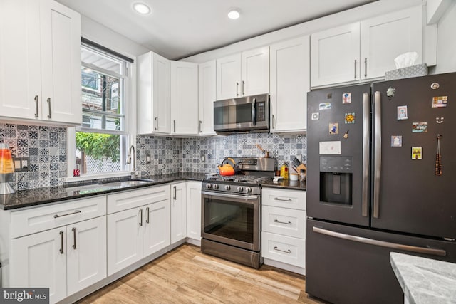 1523 N Hollywood St, Philadelphia, PA 19121 - kitchen with appliances with stainless steel finishes, a sink, white cabinetry, recessed lighting, and backsplash
