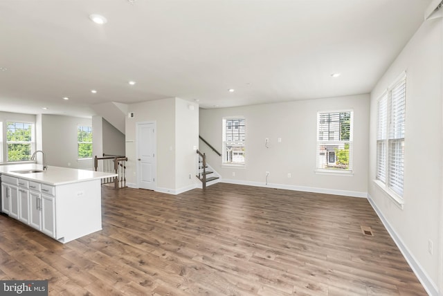 2270 Haw River Rd, Hanover, MD 21076 - unfurnished living room featuring a sink, recessed lighting, wood finished floors, baseboards, and stairs